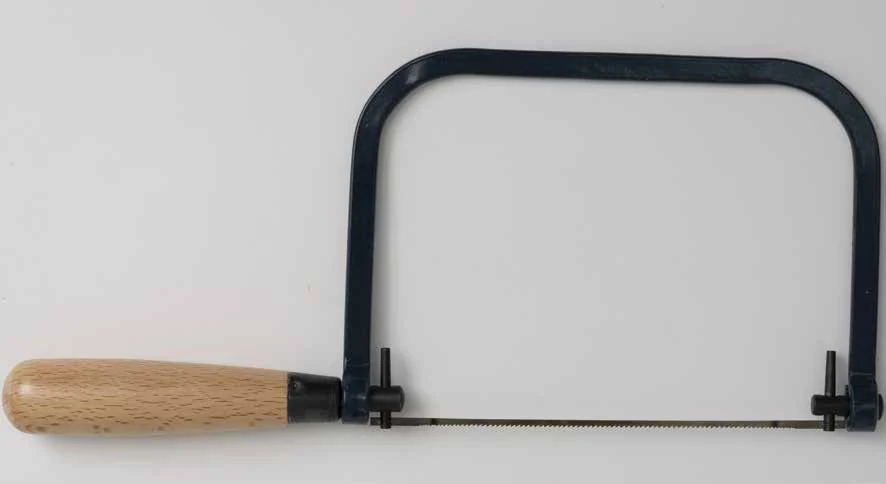 Maplewoodshop photograph of a coping saw with a U-shaped frame, wooden handle, and thin blade.
